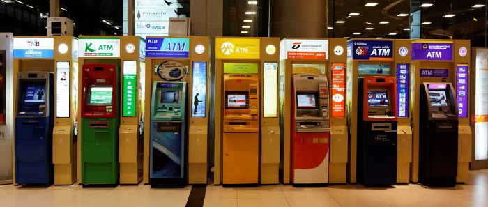 A shopping mall has three automated teller machines